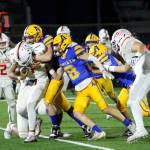 RYAN SPARKS | THE DAILY WORLD Aberdeen defenders Cole Nylander (background) and Sam Schreiber (8) tackle Steliacoom running back Noah Maxwell during the Bobcats 19-12 loss to Steliacoom on Friday in Aberdeen.