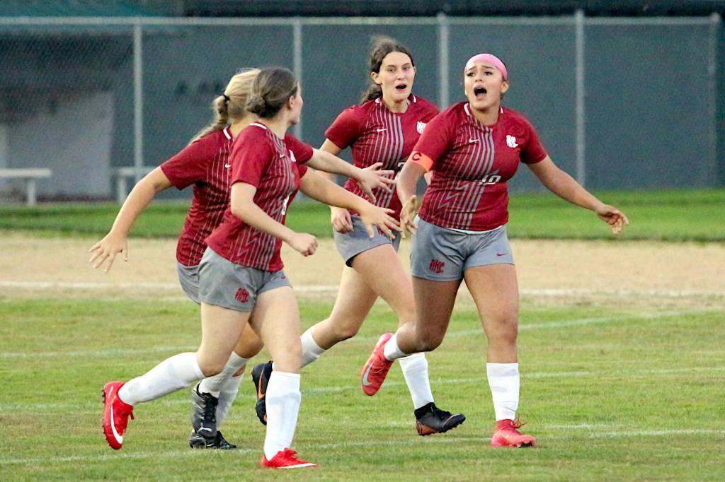 RYAN SPARKS | THE DAILY WORLD Hoquiams Brittany Alcala (right) celebrates with teammates Brooklyn Sears (8), Kenzie Stankavich (background left) and Lyric Ramstien (background right) after scoring the first Grizzlies goal of the season in the second half of a 1-1 tie on Tuesday in Hoquiam.