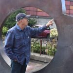 Artist Gerard Tsutakawa inspects the Illumination sculpture at the corner of I and W. Wishkah streets in Aberdeen.