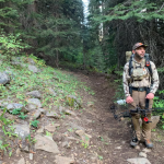Ian Isaacson stands on a trail in the Wallowa-Whitman National Forest near Lostine, Ore., in September 2025. This is one of 14 national forests that has wild areas where roadbuilding is banned. The U.S. Forest Service announced in 2025 that it plans to rescind the policy known as the "roadless rule." (Ian Isaacson)