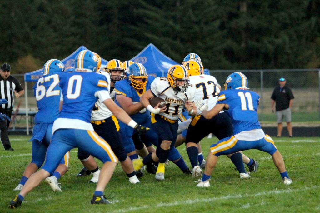 RYAN SPARKS | THE DAILY WORLD Aberdeen running back Riley Wixson (11) makes his way through the Rochester defense during a 35-20 win on Saturday at Rochester High School.