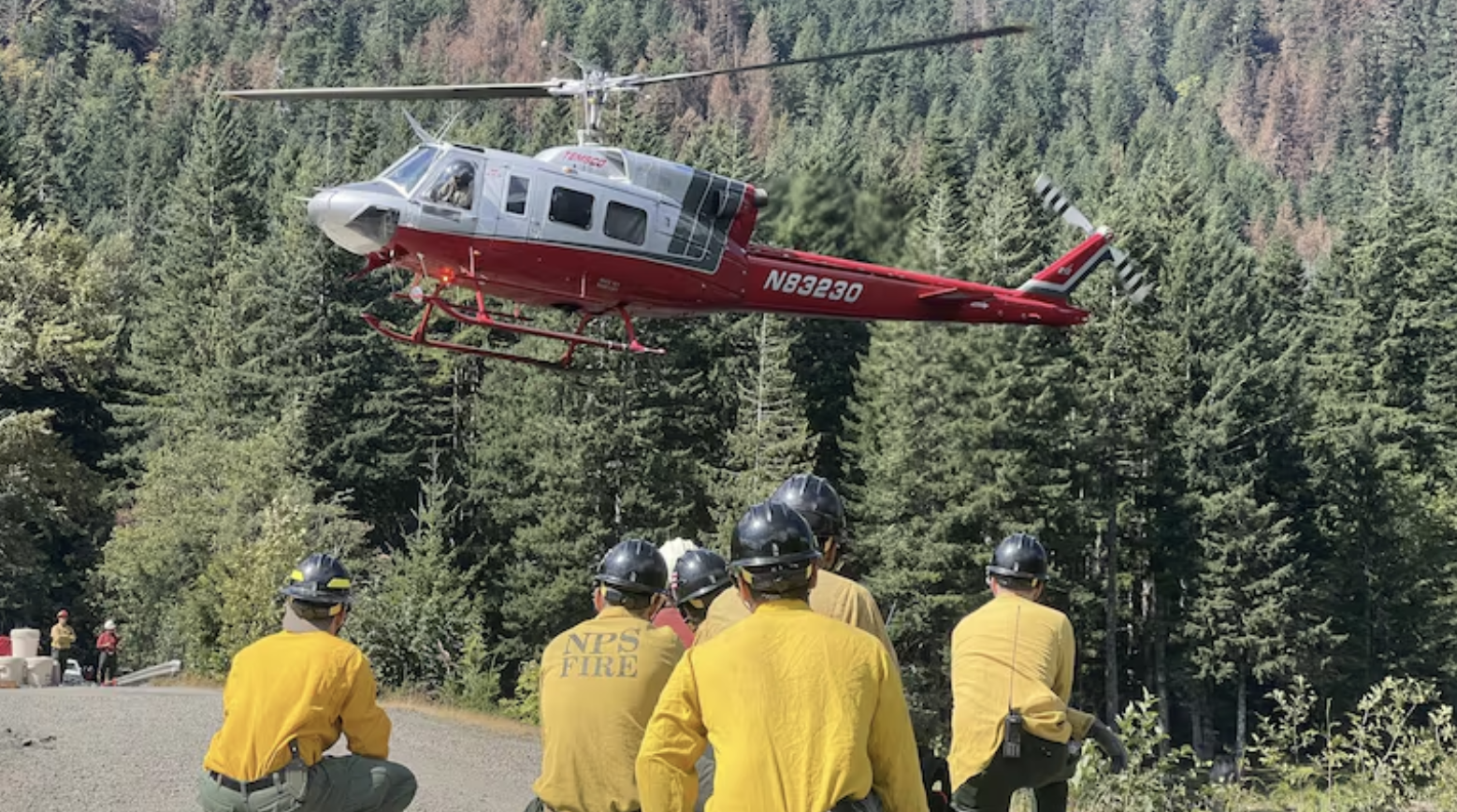 Firefighters wait to board a crew helicopter while working the Bear Gulch Fire on Washington's Olympic Peninsula in this provided image from August 2025. (Inciweb)