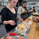 Students learn how to make a cake.