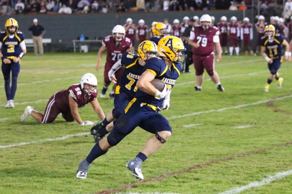RYAN SPARKS | THE DAILY WORLD Aberdeen senior running back Micah Schroeder finds some running room during a 43-7 win over Hoquiam in the 120th Myrtle Street Rivalry on Friday at Olympic Stadium in Hoquiam.