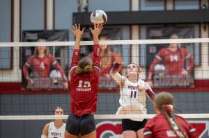 PHOTO BY FOREST WORGUM Montesano middle blocker Violet Prince (11) attempts a spike against Hoquiams Piper Stankavich (13) during the Bulldogs 3-0 win on Tuesday in Hoquiam.