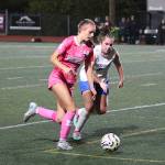 RYAN SPARKS | THE DAILY WORLD Montesano forward Lex Stanfield (left) works the ball up the field against Rochesters Chloe Hess during the Bulldogs 8-0 win on Thursday at Montesano High School.