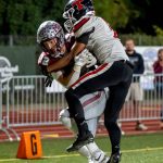PHOTO BY FOREST WORGUM Montesano wide receiver Toren Crites (12) catches a 32-yard pass for a touchdown while defended by Teninos Marvin Phillips during the Bulldogs 49-0 win on Friday at Jack Rottle Field in Montesano.