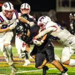 PHOTO BY MATT RUMBLES Pe Ell-Willapa Valleys Lucas Lusk (right) and Cody Mican tackle Raymond-South Bends Manny Beccera-Souza during the Titans 41-6 win on Friday at Sanchez Field in South Bend.