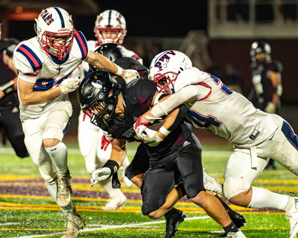 PHOTO BY MATT RUMBLES Pe Ell-Willapa Valleys Lucas Lusk (right) and Cody Mican tackle Raymond-South Bends Manny Beccera-Souza during the Titans 41-6 win on Friday at Sanchez Field in South Bend.