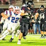 PHOTO BY MATT RUMBLES Raymond-South Bend running back Chris Banker (right) sprints away from Pe Ell-Willapa Valleys Cody Mican (22) during the Titans 41-6 victory on Friday at South Bend High School.