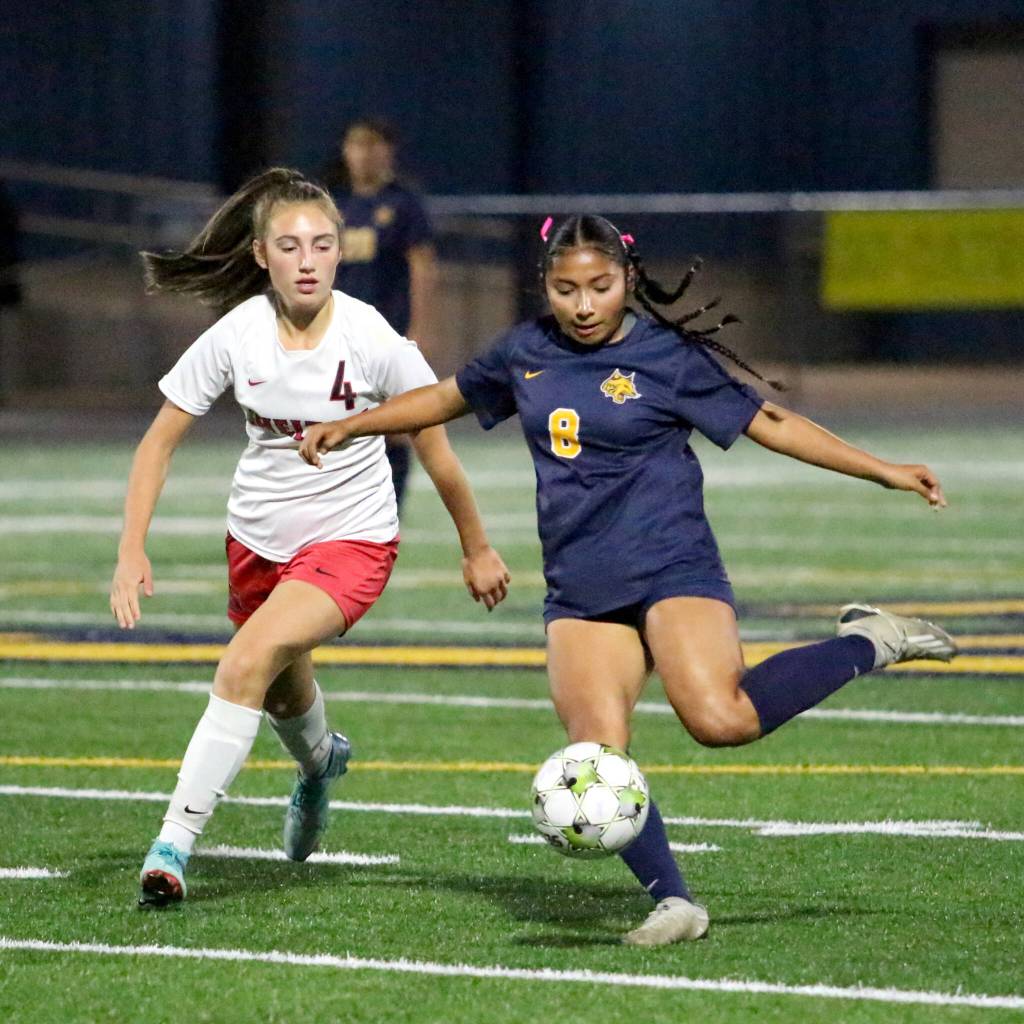 RYAN SPARKS / THE DAILY WORLD Aberdeens Nataly Barragan Salazar (8) sends the ball forward while defended by Sheltons Kya Cline during the Bobcats 1-0 win on Tuesday at Stewart Field in Aberdeen.
