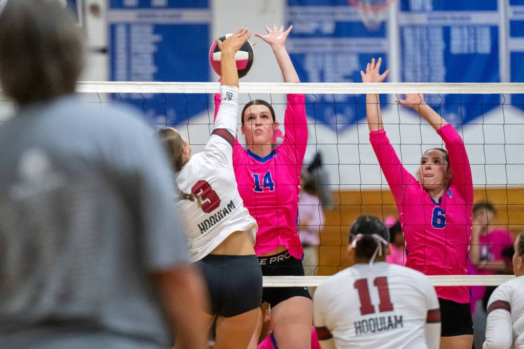 PHOTO BY FOREST WORGUM
Elma middle blockers Emily Escoffon (14) and Nani Kanios attempt to block a spike by Hoquiams Hallie Burgess (3) during a 3-0 loss on Tuesday in Elma.