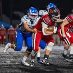 PHOTO BY FOREST WORGUM Elma lineman Marcus Jones (79) grabs a hold of Tenino running back Miguel Espinoza during the Eagles 42-0 loss on Friday in Tenino.