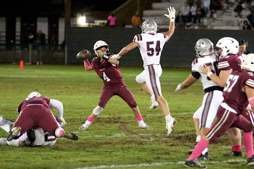 RYAN SPARKS / THE DAILY WORLD 
Hoquiam quarterback K.J. McCoy (4) has his pass blocked by Montesano linebacker Carson Wisdom during the Bulldogs 62-0 win on Friday in Hoquiam.