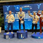 SUBMITTED PHOTO Former Elma wrestler Kevin Pine (1) stands atop the podium after winning a gold medal at the Veteran World Wrestling Championships on Friday in Hungary.
