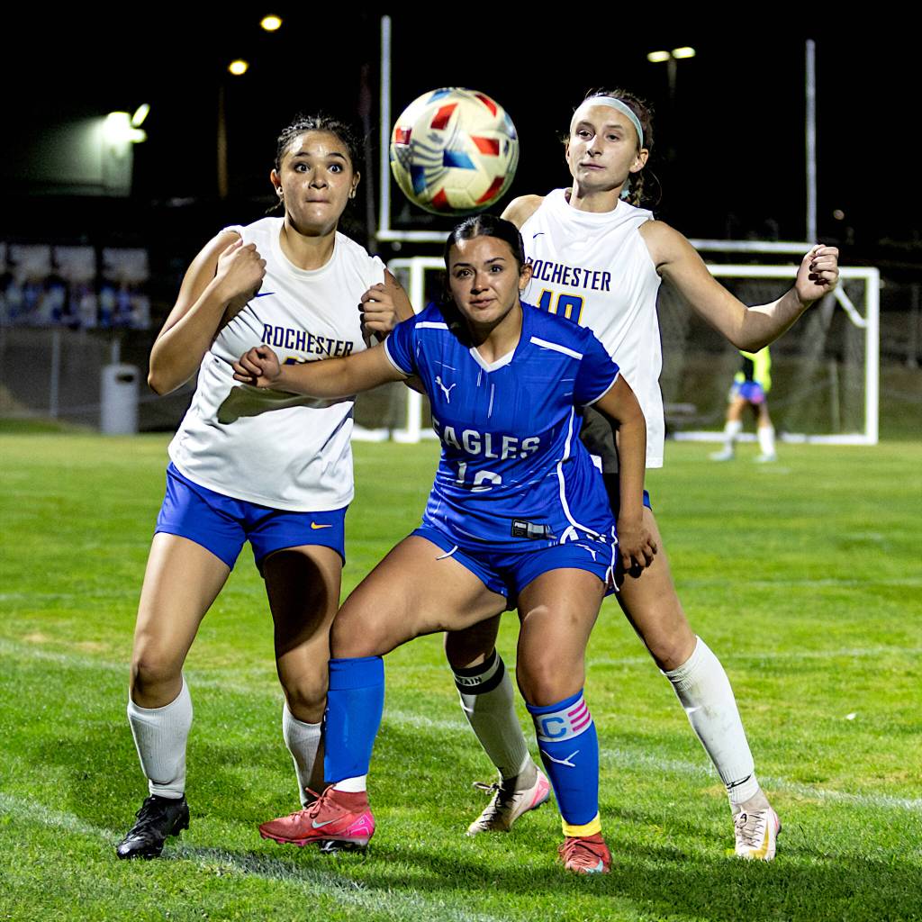 PHOTO BY MIKE ROBERTS Elma senior midfielder Maddie Barrera (middle) plays the ball during a 1-0 loss to Rochester on Tuesday at Davis Field in Elma.