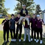 SUBMITTED PHOTO The Montesano Bulldogs pose for a photo with head coach Tyler Grajek (top) after winning the 1A Evergreen League title on Wednesday at the Tumwater Valley Golf Course.