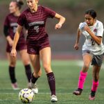 PHOTO BY FOREST WORGUM Montesano midfielder Lainey Robinson (4) looks up the field while Hoquiams Yazmine Balagot pursues during the Bulldogs 7-0 win on Thursday at Montesano High School.