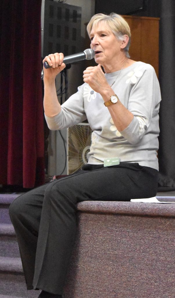 Maryann Welch, founder of 100+ Harbor Women Who Care, makes opening remarks at the October giving event.