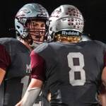 PHOTO BY FOREST WORGUM Montesano seniors Toren Crites (12) and Mason Fry celebrate after a Bulldogs touchdown during a 22-14 win over Rochester on Friday in Montesano.