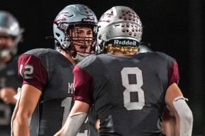 PHOTO BY FOREST WORGUM Montesano seniors Toren Crites (12) and Mason Fry celebrate after a Bulldogs touchdown during a 22-14 win over Rochester on Friday in Montesano.
