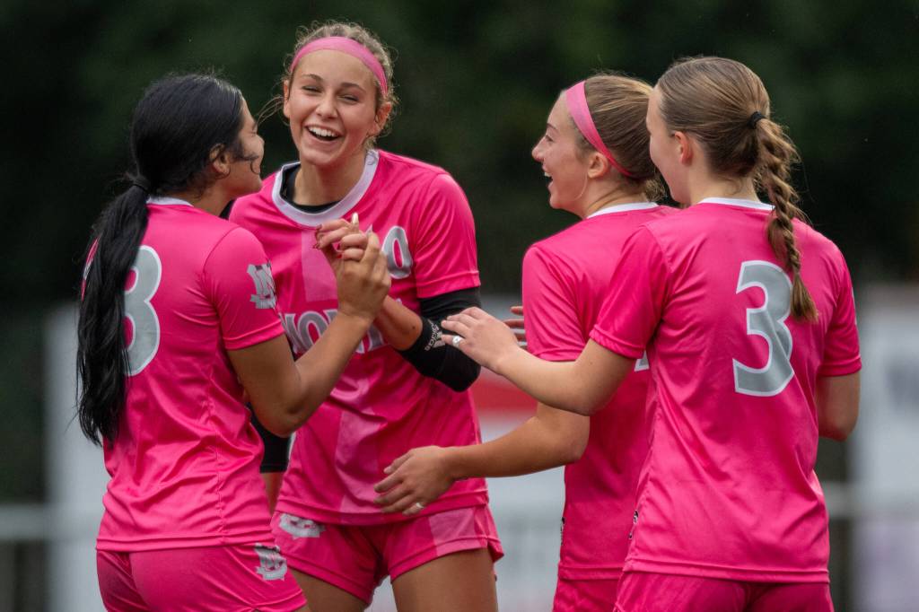 PHOTO BY FOREST WORGUM Montesano players (from left) Jaelyn Butterfield, Lex Stanfield, Lainey Robinson and Ashley Hill celebrate a Butterfield goal during a 3-0 win over Annie Wright on Saturday in Montesano.