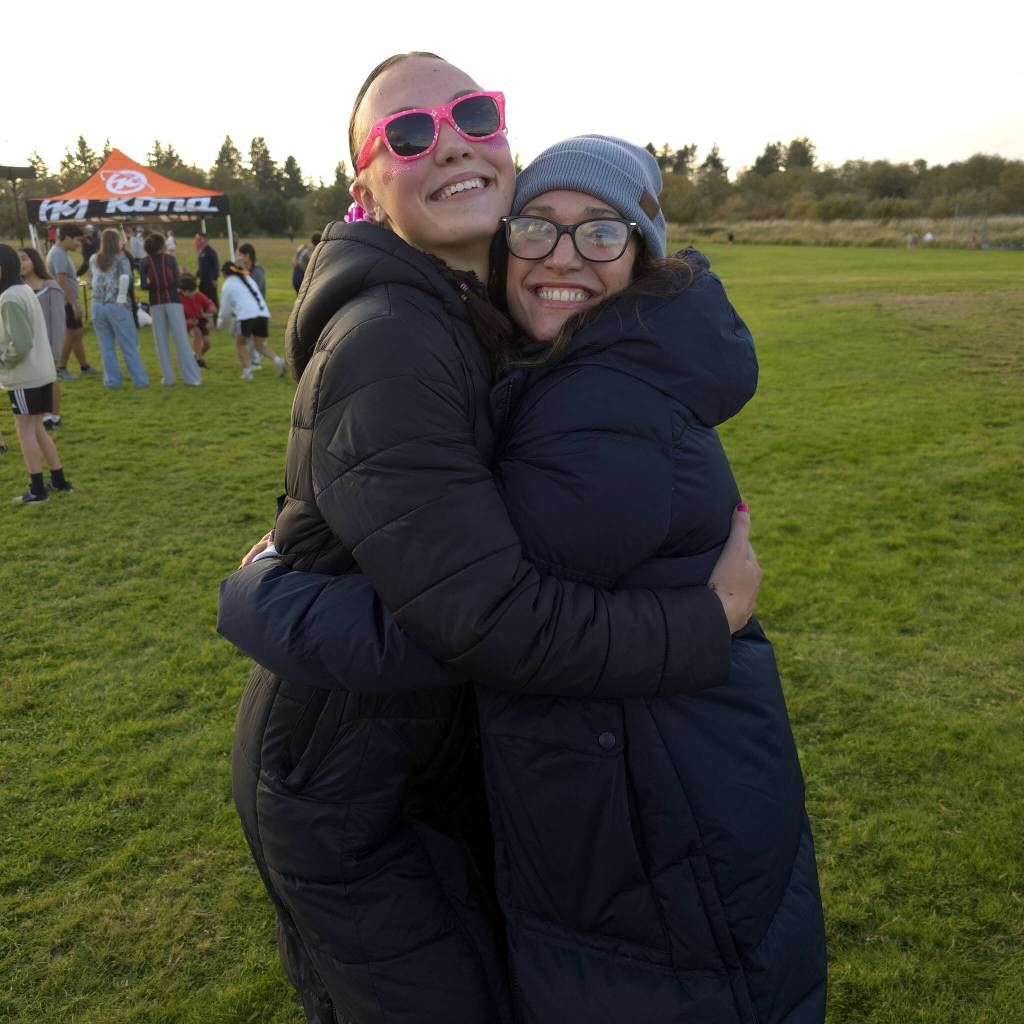 RYAN SPARKS | THE DAILY WORLD Aberdeens Ailyn Haggard (left) is congratulated by Bobcats volleyball/track & field head coach Desiree Glanz after Haggard won the league-title race on Wednesday in Aberdeen.
