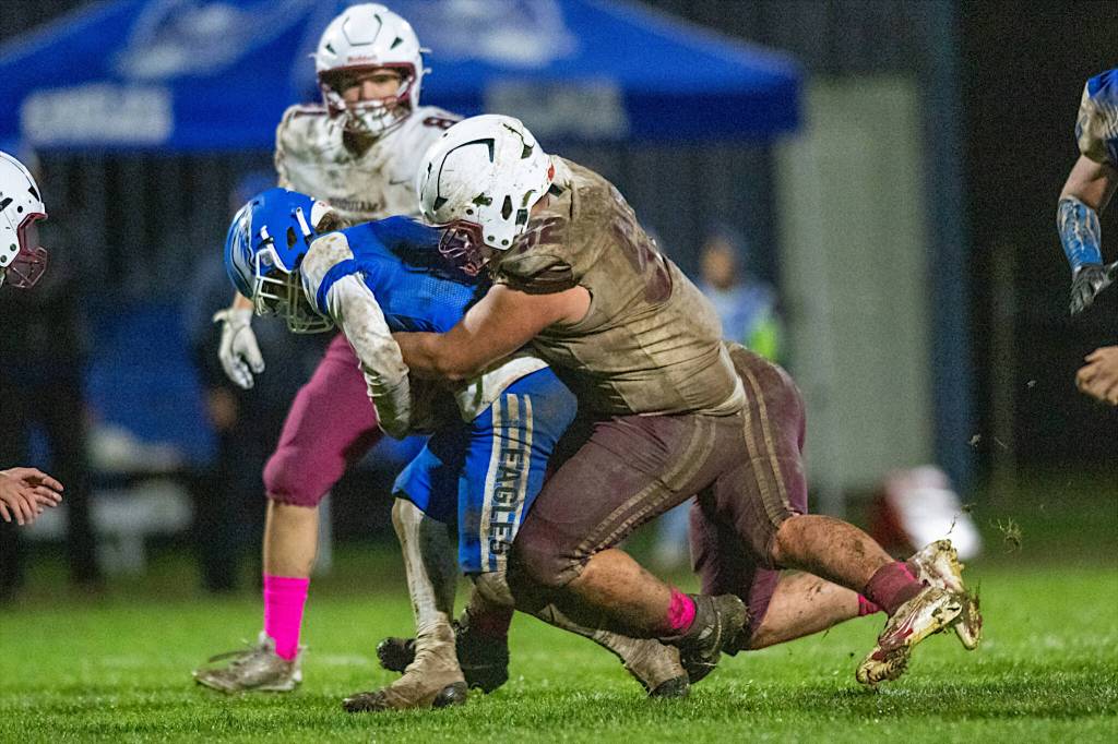 PHOTO BY FOREST WORGUM Hoquiam defensive lineman Ryan Pullar (right) makes a tackle during a 13-9 loss to Elma on Friday at Davis Field in Elma.