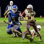 PHOTO BY MIKE ROBERTS Elma quarterback Isaac McGaffey (left) is pursued by Hoquiam defender Tristan Turpin during the Eagles 13-9 win over Friday in Elma.