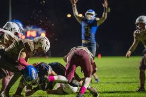 PHOTO BY FOREST WORGUM Elma quarterback Isaac McGaffey (background) celebrates teammate Kolby Rademacher scoring the game-winning touchdown in a 13-9 victory over Elma on Friday in Elma.