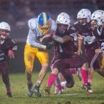 PHOTO BY FOREST WORGUM Hoquiam defender Joey Bozich (1) attempts to rip the ball away from Rochester running back Ethan Rodriguez during the Grizzlies 52-0 loss on Friday at Olympic Stadium in Hoquiam.