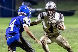 PHOTO BY MIKE ROBERTS Montesano running back Zach Timmons (right) faces off against Elma defensive back Trey Sample during the Bulldogs 42-6 victory on Friday at Elma High School.