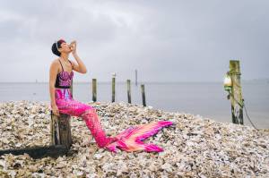 International Mermaid Museum photos
A mermaid enjoys slurping down an oyster on the shores of Grays Harbor. The International Mermaid Museum Festival will fill the month of March.