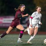 PHOTO BY FOREST WORGUM Montesano forward Lex Stanfield (left) sprints away from Cascade Christians Keira Ripka during the Bulldogs 4-0 victory in a 1A State Tournament first-round game on Wednesday in Montesano.