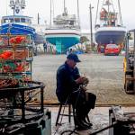 Erik Ervest repairs rope on a crab pot inside a covered building at the Ilwaco Boatyard last week. Washington commercial fishing crews are busy making final preparations for the upcoming Dungeness crab season, the most prized fishery in the Pacific Northwest.