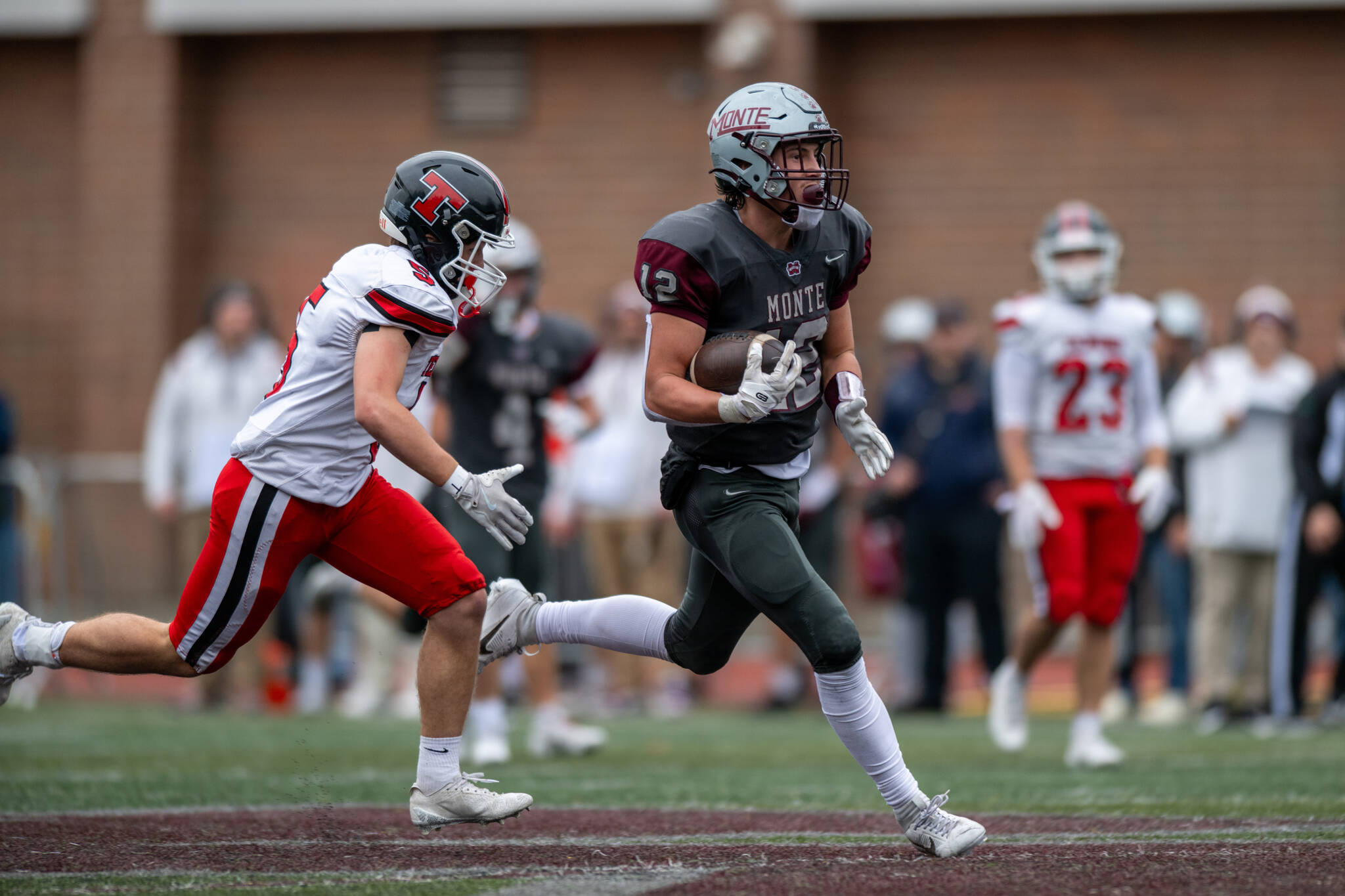PHOTO BY FOREST WORGUM Montesano receiver Toren Crites (right) sprints away from a Tenino defender during a 49-7 victory in a 1A State Tournament first-round game on Saturday in Montesano.