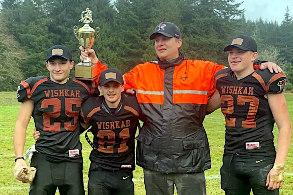 SUBMITTED PHOTO Wishkah Valleys (from left) Kohl Brandner, Evan Davenport, head coach Eric Erickson and Boady Dhooghe pose for a photo after winning the 1B Coastal League 6-man Championship over Mary M. Knight on Saturday at Wishkah Valley High School.