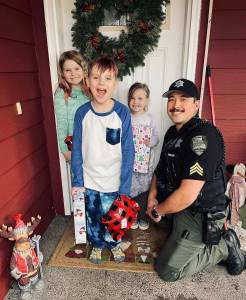 The Daily World file photo
Sgt. Stephen Heller helps distribute toys during last years Grays Harbor County Sheriffs Department Holiday Toy Drive.