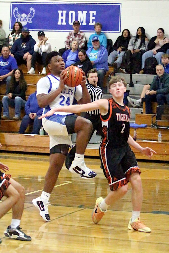 RYAN SPARKS | THE DAILY WORLD Elmas Tyrone Aguilar (24) drives to the rim against Centralias Trevor Griffis during the Eagles 66-56 victory on Tuesday at Elma High School.