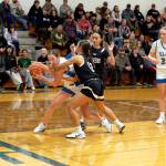 NICOLE SHANNON | MAIN FOCUS MEDIA
Elma's Mercedes Carter (left) is guarded by Raymond-South Bend's Maddie San (12) and Megan Kongbouakhay during a 57-28 loss on Thursday at Elma High School.