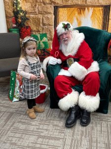 Jerry Knaak / The Daily World
Santa Claus poses for a photo with a shy young visitor at the Ocean Shores Public Library.