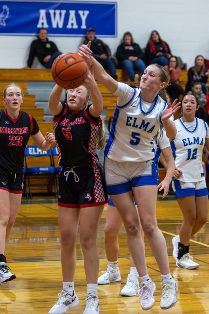 PHOTO BY MIKE ROBERTS Elmas Mikayla Roberts (right) competes makes a play on the ball against Mossyrocks Brooke Schwartz during the Eagles 51-39 loss on Monday in Elma.