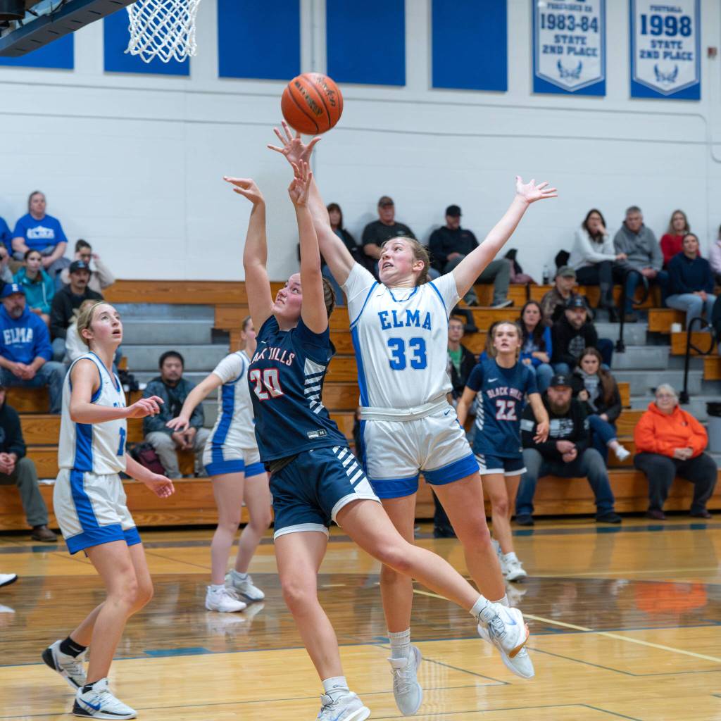 NICOLE SHANNON | MAIN FOCUS MEDIA Elmas Olivia Moore (33) leaps for a rebound during a 59-49 loss to Black Hills on Tuesday at Elma High School. Moore led all scorers with 28 points.
