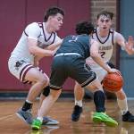 PHOTO BY FOREST WORGUM Montesanos Colton Grubb (left) and Ryan Weidman defend W.F. Wests Alex Stafford during a 54-48 overtime victory on Thursday in Montesano.