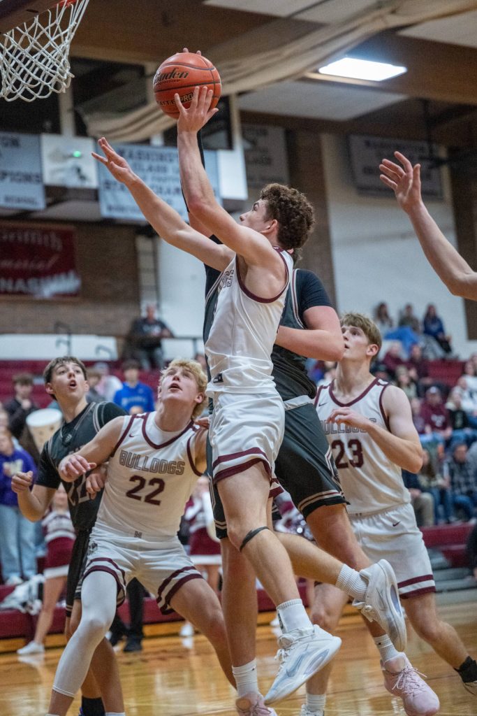 PHOTO BY FOREST WORGUM Montesanos Terek Gunter (middle) drives to the hoop during a 54-48 overtime win against W.F. West on Thursday at Montesano High School.