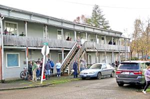 Jeff Clemens photos
Residents at the apartment complex located at 400 Ninth St in Raymond speak with officials from the City of Raymond and resource organizations after notices were posted condemning the building on Dec. 19. The residents had until until Monday to vacate before the building was boarded up.