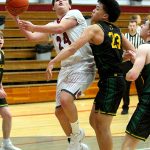 RYAN SPARKS | THE DAILY WORLD Hoquiams Lincoln Niemi (24) scores and is fouled by Overlakes Derek Li during the Grizzlies 55-54 win on Tuesday at Hoquiam High School.