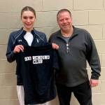 SUBMITTED PHOTO Raymond-South Bend senior Ava Baugher (left) poses for a photo with head coach Jason Koski after reaching the 500 rebound club in a game on Tuesday, Dec. 23.