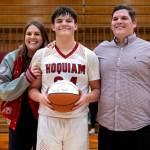 PHOTO BY FOREST WORGUM Hoquiam junior Lincoln Niemi (middle) is flanked by his parents Aubra (left) and Jeff Niemi after becoming the fifth Grizzly to eclipse 1,000 points during a 69-52 win over Steliacoom on Saturday at Hoquiam High School.