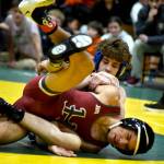 PHOTO BY SUE MICHALAK BUDSBERG Elmas Aidyn Johnson (background) and Hoquiams Junior Balagot wrestle in the 126-pound championship match of The Rock Tournament on Tuesday at Vashon Island High School.